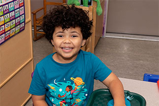 A boy smiling. Links to Gifts of Cash, Checks, and Credit Cards