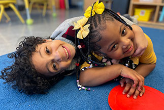 Two children playing. Links to Gifts by Estate Note
