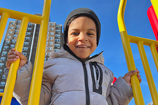 A boy on a playground. Links to Tangible Personal Property