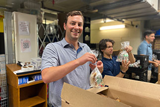 A volunteet packing bread in a box. Links to Gifts of Appreciated Securities